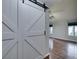 Living room with hardwood floors and a stylish barn door at 2714 Bridgepointe Dr, Las Vegas, NV 89121