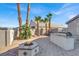 Outdoor kitchen with built-in BBQ and fire pit at 278 Iron Duke Ave, Las Vegas, NV 89183