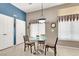 Bright dining area with white doors, large windows, tile flooring, and modern furnishings at 278 Iron Duke Ave, Las Vegas, NV 89183