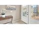 Elegant foyer with a decorative glass door, a modern console table and neutral decor at 278 Iron Duke Ave, Las Vegas, NV 89183