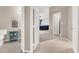 Hallway with a view into the powder room and main bedroom, with tile flooring throughout at 278 Iron Duke Ave, Las Vegas, NV 89183