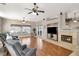 Bright living room with a ceiling fan, fireplace, and view of the backyard through sliding glass doors at 278 Iron Duke Ave, Las Vegas, NV 89183