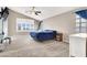 Main bedroom featuring carpet, a ceiling fan, large window with shutters, and a blue accent wall at 278 Iron Duke Ave, Las Vegas, NV 89183