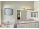 Double vanity bathroom with granite countertop, large mirror, and a soaking tub at 279 Windsong Echo Dr, Henderson, NV 89012