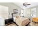 Bedroom with a beige comforter, wood floors, and window shutters at 279 Windsong Echo Dr, Henderson, NV 89012