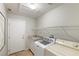 Laundry room with washer, dryer, and ample shelving at 279 Windsong Echo Dr, Henderson, NV 89012