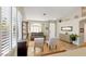 Living room with gray couch, tile floors, and built-in shelving at 279 Windsong Echo Dr, Henderson, NV 89012