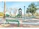 Community playground with slides, climbing structures, and benches at 279 Windsong Echo Dr, Henderson, NV 89012