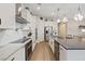 Modern kitchen with white cabinets, large island, and stainless steel appliances at 3018 Fall Solstice Ct, Las Vegas, NV 89138