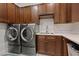 Laundry room with modern washer, dryer, and ample cabinetry at 3018 Fall Solstice Ct, Las Vegas, NV 89138