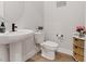 Stylish powder room with pedestal sink and modern fixtures at 3018 Fall Solstice Ct, Las Vegas, NV 89138