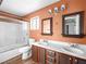 Bathroom featuring a double sink vanity, large mirrors, and a glass-enclosed shower at 3038 Casey Dr # 204, Las Vegas, NV 89120