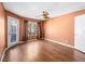 Inviting bedroom features wood floors, neutral walls, a ceiling fan, and a door to the outside at 3038 Casey Dr # 204, Las Vegas, NV 89120