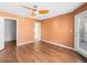 Spacious bedroom featuring wood floors, ceiling fan, and access to closet and balcony at 3038 Casey Dr # 204, Las Vegas, NV 89120