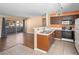Well-lit kitchen with stainless steel sink, ample cabinetry, and a breakfast bar, seamlessly connected to the living area at 3038 Casey Dr # 204, Las Vegas, NV 89120