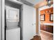 Compact laundry room features a stacked washer and dryer near the bathroom at 3038 Casey Dr # 204, Las Vegas, NV 89120