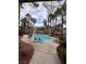 Community pool with palm trees and patio furniture at 3038 Casey Dr # 204, Las Vegas, NV 89120