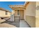 Front entrance with a covered porch and wrought iron gate at 3060 Lapis Beach Dr, Las Vegas, NV 89117