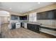 Modern kitchen features dark wood cabinets, granite countertops, and hardwood floors at 3060 Lapis Beach Dr, Las Vegas, NV 89117