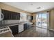 Kitchen with dark cabinets, stainless steel appliances, and sliding glass door to backyard at 3060 Lapis Beach Dr, Las Vegas, NV 89117