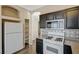 Kitchen features white appliances, dark cabinets and pantry at 3060 Lapis Beach Dr, Las Vegas, NV 89117