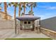 Backyard patio with gazebo, seating area, and artificial turf at 3119 Crownline Ct, North Las Vegas, NV 89031