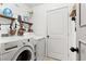 Laundry room with washer, dryer, and shelving at 3119 Crownline Ct, North Las Vegas, NV 89031