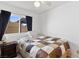 Quaint bedroom with a patchwork quilt, ceiling fan, and window with black-out curtains at 3280 James A Bilbray Pkwy, Laughlin, NV 89029