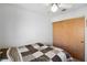 Bedroom with a patterned quilt and sliding wood closet doors at 3280 James A Bilbray Pkwy, Laughlin, NV 89029