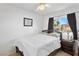 Cozy bedroom with a wood-frame bed, ceiling fan, and natural light from the window at 3280 James A Bilbray Pkwy, Laughlin, NV 89029