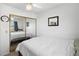 Comfortable bedroom featuring mirrored closet doors, a ceiling fan, and bright, natural light at 3280 James A Bilbray Pkwy, Laughlin, NV 89029