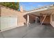 Spacious covered carport featuring a secure white gate, providing ample parking and protection from the elements at 3280 James A Bilbray Pkwy, Laughlin, NV 89029