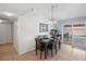 Inviting dining area featuring a modern light fixture and sliding door access to the outdoor pool at 3280 James A Bilbray Pkwy, Laughlin, NV 89029