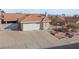 Inviting home with a terracotta roof, attached two-car garage, and a well-manicured front yard at 3280 James A Bilbray Pkwy, Laughlin, NV 89029