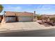 Single-story home with a tile roof, two-car garage, and a spacious driveway in a quiet neighborhood at 3280 James A Bilbray Pkwy, Laughlin, NV 89029