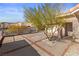 Paver-lined driveway and front yard featuring desert landscaping and a decorative tree at 3280 James A Bilbray Pkwy, Laughlin, NV 89029