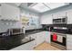 Kitchen featuring black granite countertops, white cabinetry, stainless steel appliances, and backsplash at 3280 James A Bilbray Pkwy, Laughlin, NV 89029