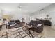 Living room featuring neutral walls, tile floor, mirrored wall, ceiling fan, and comfortable seating arrangement at 3280 James A Bilbray Pkwy, Laughlin, NV 89029