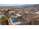 Expansive aerial view of the backyard pool, covered patio, desert landscape, and mountains in the background at 3280 James A Bilbray Pkwy, Laughlin, NV 89029