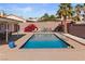 Relaxing backyard oasis with a sparkling swimming pool, mature landscaping, and serene lounge area at 3280 James A Bilbray Pkwy, Laughlin, NV 89029