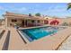 Lovely backyard showcasing a sparkling pool, covered patio, and lush landscaping for relaxation and enjoyment at 3280 James A Bilbray Pkwy, Laughlin, NV 89029