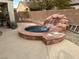 Backyard oasis with a spa and waterfall feature at 3310 Fernbird Ln, North Las Vegas, NV 89084