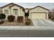 One-story house with attached garage and manicured landscaping at 3310 Fernbird Ln, North Las Vegas, NV 89084