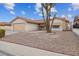 Single-story house with a beige exterior, tile roof, and a two-car garage at 350 Preston Dr, Henderson, NV 89015