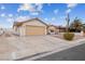 Single-story house with a beige exterior, tile roof, and a two-car garage at 350 Preston Dr, Henderson, NV 89015