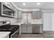 Modern kitchen with gray cabinets and stainless steel appliances at 350 Preston Dr, Henderson, NV 89015