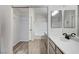 Bathroom with double vanity, tub, and mirrored closet at 3708 Penny Cross Dr, North Las Vegas, NV 89032