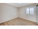 Simple bedroom with wood-look floors and window with shutters at 3708 Penny Cross Dr, North Las Vegas, NV 89032