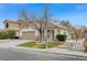 Single-story house with tan exterior, brown garage door, and a tree in front at 3708 Penny Cross Dr, North Las Vegas, NV 89032