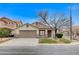 Single-story house with tan exterior, brown garage door, and a tree in front at 3708 Penny Cross Dr, North Las Vegas, NV 89032